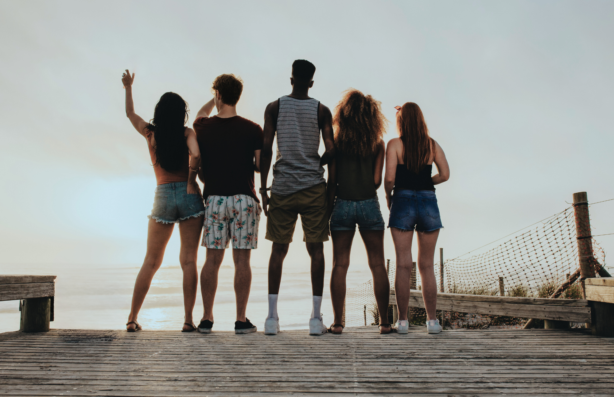 men and women friends looking out at laguna beach during addiction recovery