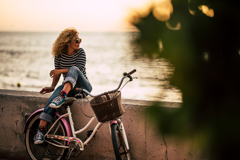 woman sitting by the beach during residential addiction recovery