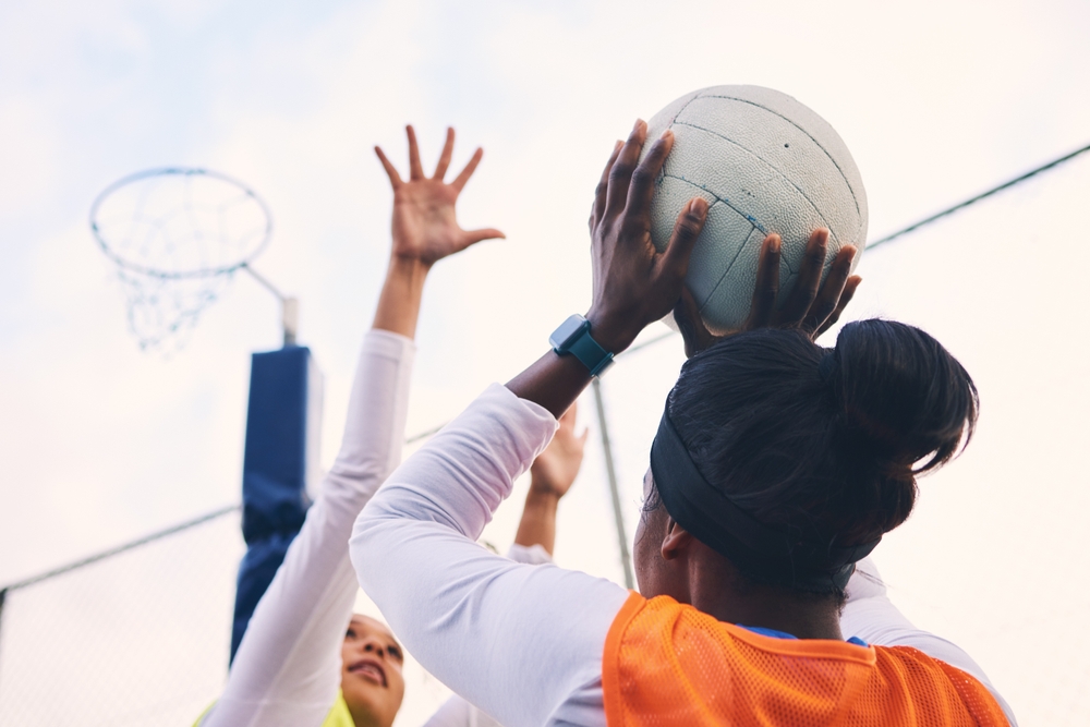 two women playing with a ball during rehab